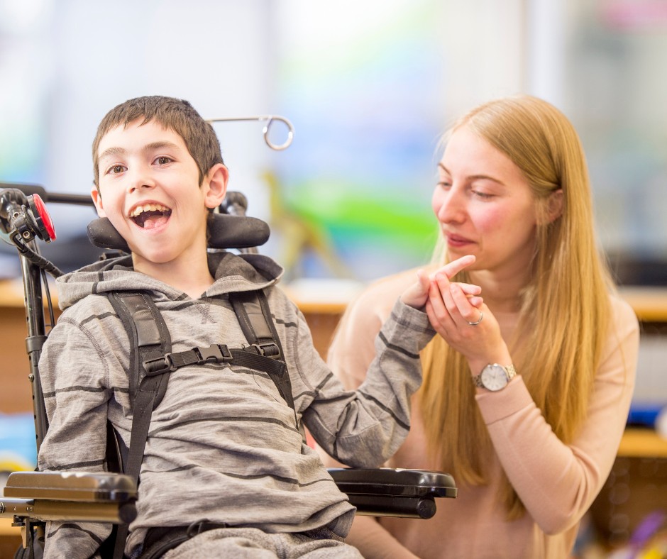 mental disabled boy smiling at a white lady